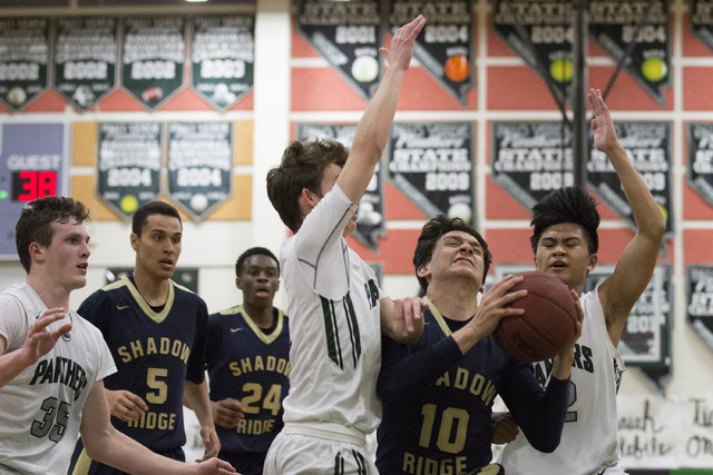 Shadow Ridge sophomore Garin Macfarlan attempts to make a shot at Palo Verde High School on ...