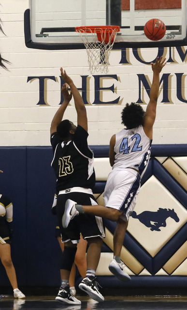 Centennial’s Jamaal Evans (42) shoots over Clark’s Antwon Jackson (23) during th ...