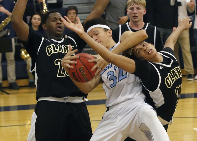 Centennial’s Darian Scott (32) struggles to keep the ball as Clark’s Antwon Jack ...