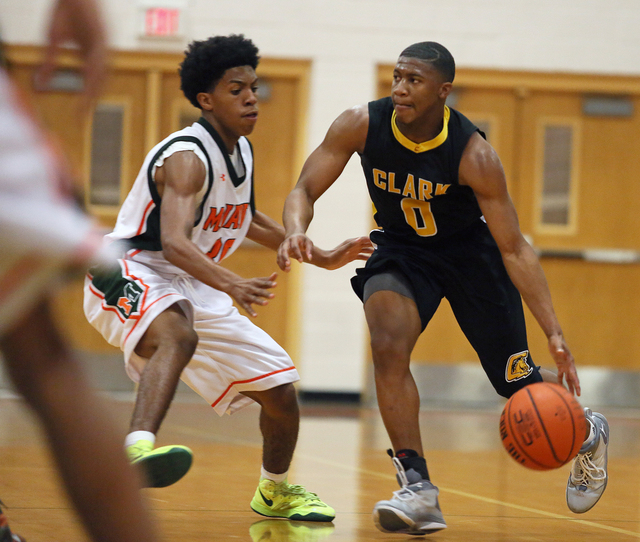 Clark’s Colby Jackson, right, dribbles the ball past Mojave’s Lamaja Cunningham duri ...