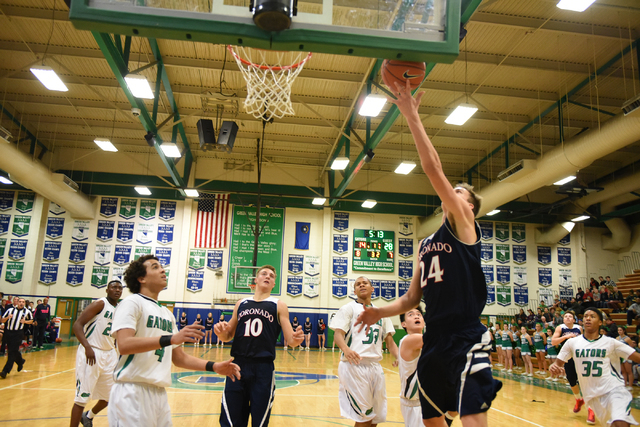 Coronado’s Jake DesJardins (24) shoots the ball against Green Valley’s defense o ...