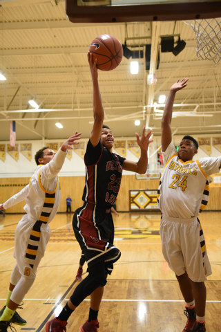 Desert Oasis guard Rodrick Moore (23) shoots the ball against Bonanza guard Travis Jenkins, ...