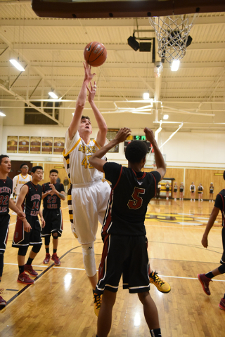 Bonanza forward John Holden (42) shoots the ball over Desert Oasis forward Aamondae Coleman ...