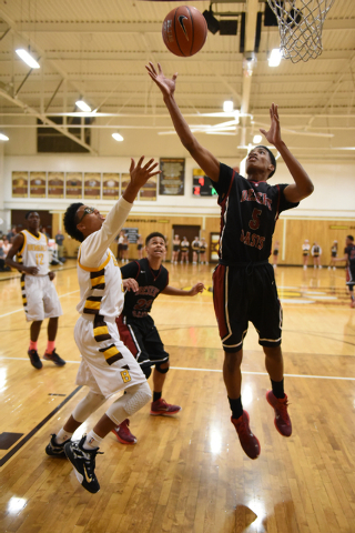 Desert Oasis forward Aamondae Coleman (5) grabs the rebound against Bonanza forward Jacob Pe ...