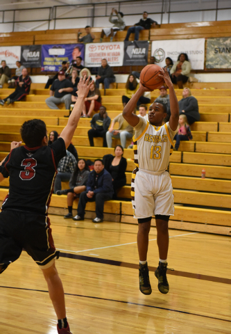 Bonanza guard Jamal Logan (13) shoots the ball over Desert Oasis guard Andrue Aguilera (5) o ...