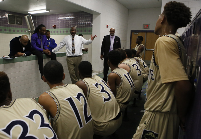 Cheyenne head coach Teral Fair speaks to his players at halftime during a boys basketball ga ...