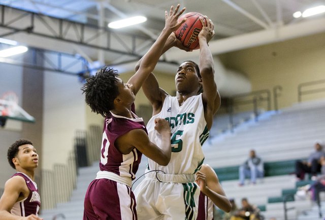 Rancho Rams Senior Justin Holiday (15), shoots the ball while Agassi Prep Junior Akeemis (0) ...