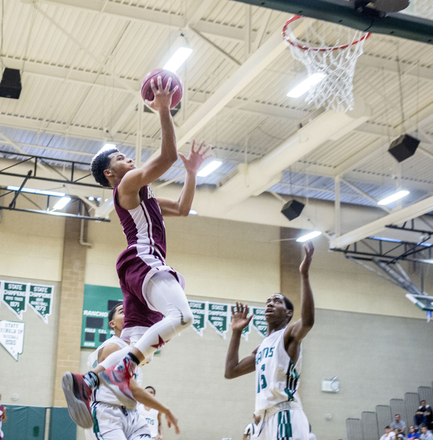 Agassi Prep Guard Allen Merritt, (5), shoots the ball against the Rancho Rams at Rancho High ...