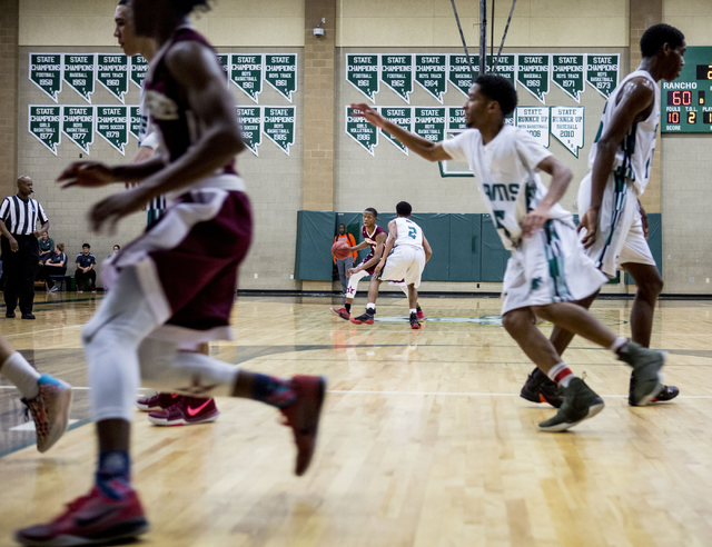 Agassi Prep Guard Najeeb Muhammad, (1), shoots the ball against the Rancho Rams at Rancho Hi ...