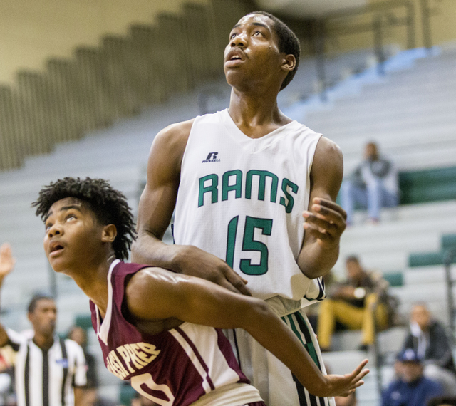 Rancho Rams Senior Justin Holiday (15), shot the ball while he and Agassi Prep Juior Akeemis ...