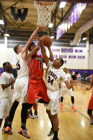 LaSalle’s Javan Burnom (1) goes up for a shot between Legacy’s Brody Olenslager ...