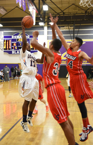 Legacy’s Anthony Buchanan (11) goes up for a shot over LaSalle’s Isiah Spencer-L ...