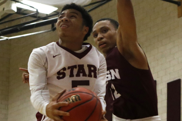 Agassi’s Allen Merritt (50) shoots a layup over Innovations International’s Just ...