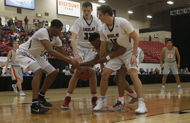 Bishop Gorman’s Chuck O’Bannon (5) struggles to keep control of the ball as he i ...