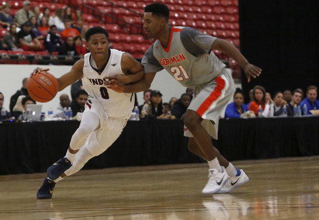 Findlay Prep’s Justin Roberts (0) drives pass Bishop Gorman’s Christian Popoola ...