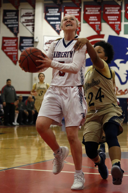 Liberty’s London Pavlica (5) is fouled by Spring Valley’s Deja McDonald (24) dur ...