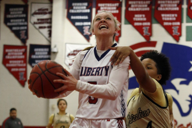 Liberty’s London Pavlica (5) is fouled by Spring Valley’s Deja McDonald (24) dur ...