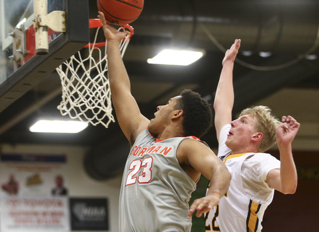 Bishop Gorman Ryan Kiley (23) gets a shot in over Clark’s Trey Woodbury (22) during a ...