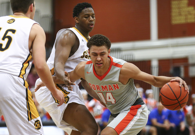 Bishop Gorman’s Saxton Howard (14) drives past Clark’s Antwon Jackson (23) durin ...