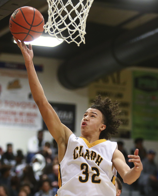 Clark’s Ian Alexander (32) goes up for a shot against Bishop Gorman during a basketbal ...