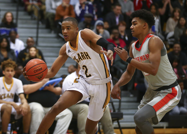 Clark’s Sedrick Hammond (2) drives past Bishop Gorman’s Jamal Bey (2) during a b ...