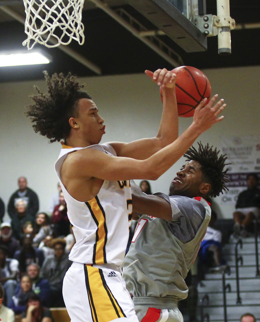 Clark’s Ian Alexander (32) loses control of the ball as Bishop Gorman’s Christia ...