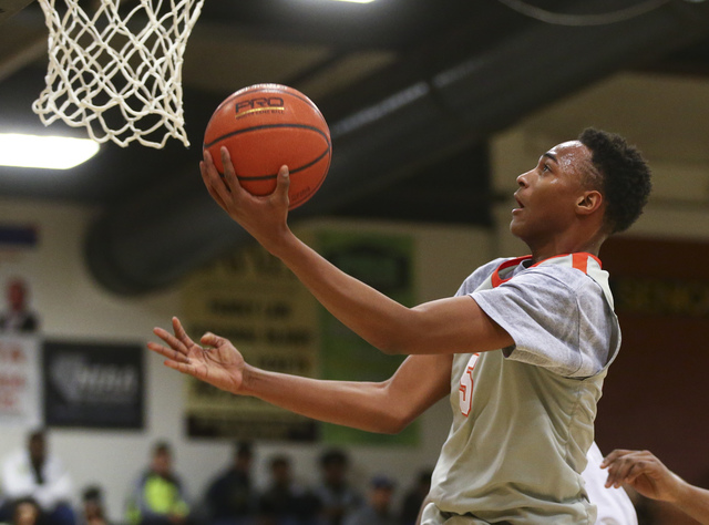 Bishop Gorman’s Chuck O’Bannon (5) goes up to the basket against Clark during a ...