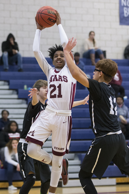 Agassi Prep’s Ahmiere Mosby (21) goes up for a shot against Mountain View in the boy&# ...