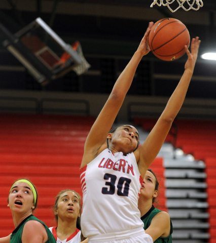 Liberty’s Paris Strawther (30) grabs a rebound over Green Valley’s Ellee Barton, ...