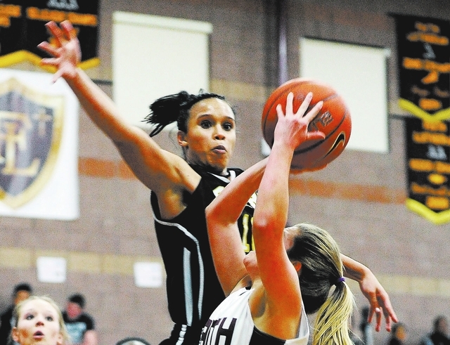 Clark’s Bobbi Floyd lines up to block a shot by Faith Lutheran’s Dani Tharaldson ...