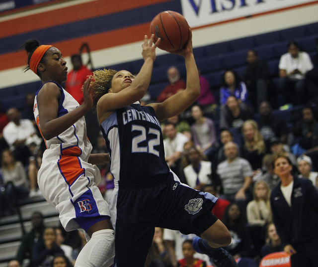 Centennial’s Teirra Hicks (22) drives to the hoop against Bishop Gorman’s Maddis ...