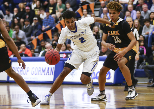 Bishop Gorman Jamal Bey (2) drives to the basket past Clark forward Jalen Hill (20) during a ...