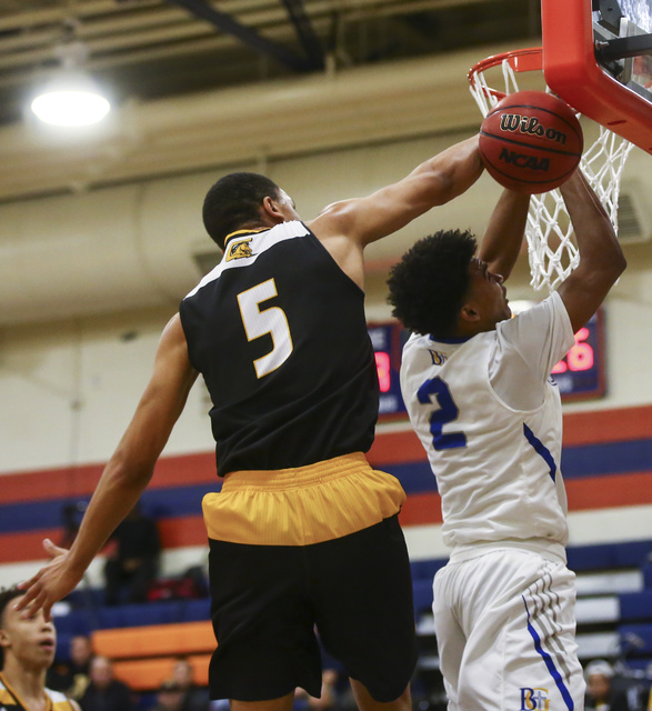 Clark forward Deshawn Wilson (5) blocks a shot from Bishop Gorman Jamal Bey (2) during a bas ...