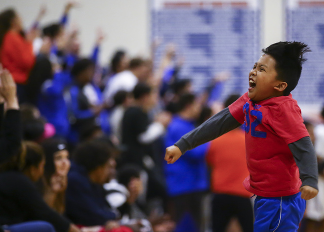 Bishop Gorman supporter Derek Octaviano, 10, cheers after the basketball team scored against ...