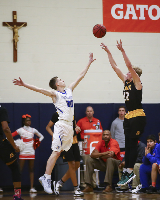 Clark guard Trey Woodbury (22) attempts a three-pointer as Bishop Gorman guard Noah Taitz (2 ...