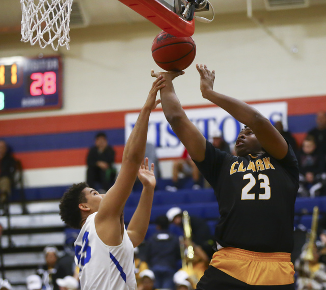 Clark forward Antwon Jackson (23) goes up for a shot as Bishop Gorman forward Ryan Kiley (23 ...