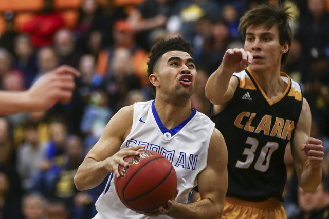 Bishop Gorman guard Jarrett Jordan (0) drives to the basket as Clark forward Adam Forbes (30 ...