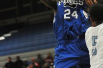 Desert Pines’ Nate Grimes (24) takes a shot over Canyon Springs’ Gerad Davis on ...