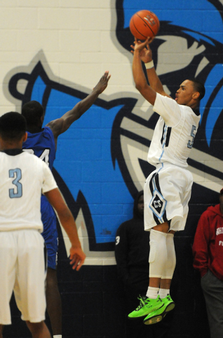 Canyon Springs’ Gerad Davis (5) takes a shot over Desert Pines’ Nate Grimes (24) ...