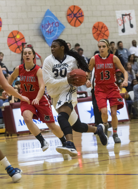 Agassi Prep guard Sharmayne Finley (30) drives the ball during a game against Lincoln County ...