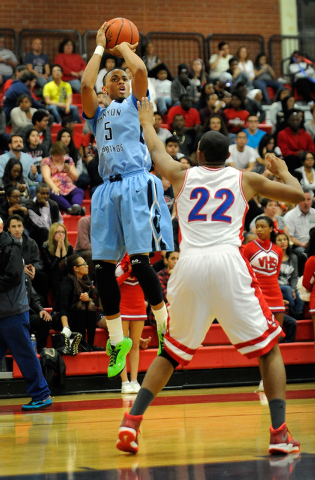 Canyon Springs’ Gerad Davis (5) shoots over Valley’s Shea Garland earlier this s ...