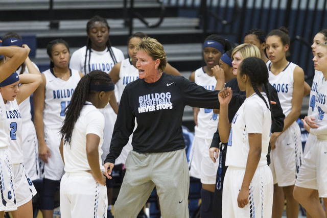 Centennial head girls basketball coach Karen Weitz talks to her players during a time out in ...