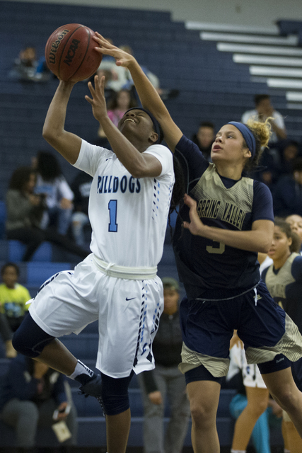 Centennial’s Pam Wilmore (1) goes up for a shot against Spring Valley’s Essence ...