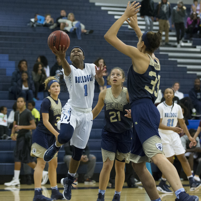 Centennial’s Pam Wilmore (1) goes up for a shot against Spring Valley in the girls bas ...