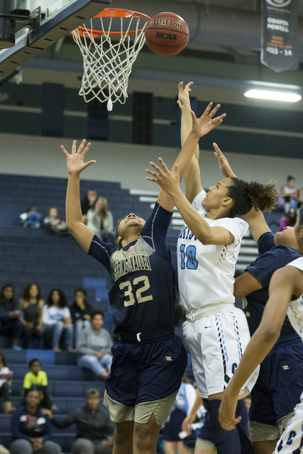 Centennial’s Jayden Eggleston (10) goes up for a shot against Spring Valley in the gir ...