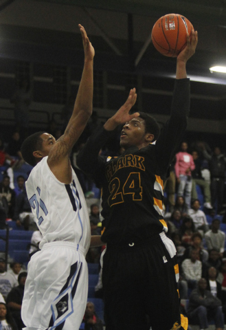 Clark’s Diontae Jones (24) shoots over Canyon Springs’ Darrell McCall (21) on Fr ...