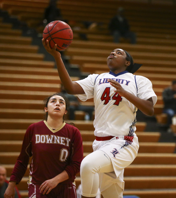 Liberty’s Dre’una Edwards (44) goes up to score as Downey’s Lynette Garcia ...