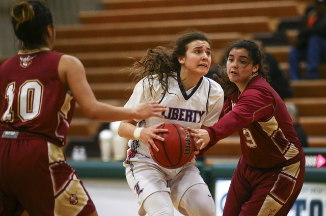 Liberty’s Celine Quintino (3) looks to shoot as Downey’s Naelene Garcia (3) def ...