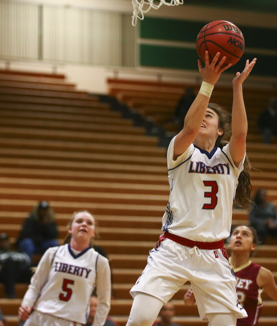 Liberty’s Celine Quintino (3) goes up for a shot against Downey during the Gator Winte ...