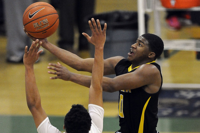 Clark guard Colby Jackson goes up for a layup against Desert Pines guard Coby Myles (13) dur ...